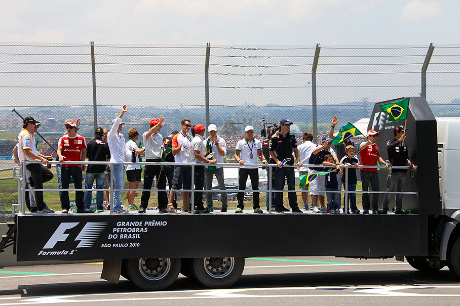 The drivers wave from the vehicle