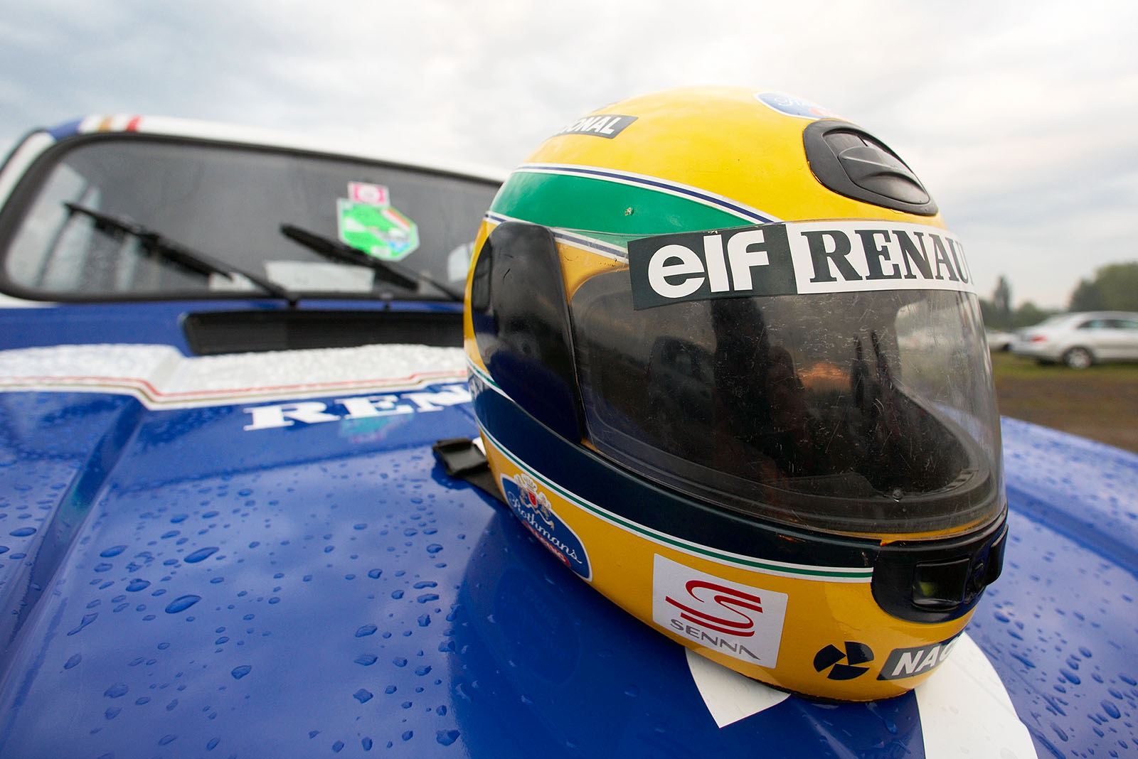 The Slovenian journalist Miran Alisic shows off with his historic Renault R4 in original Williams livery and his self made Senna helmet