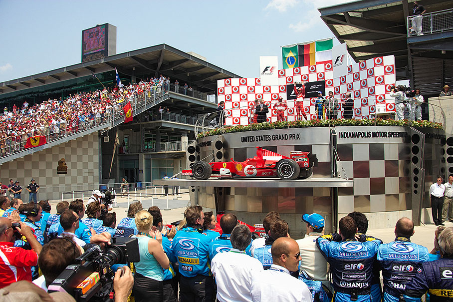 Podium ceremony with winnning car in foreground