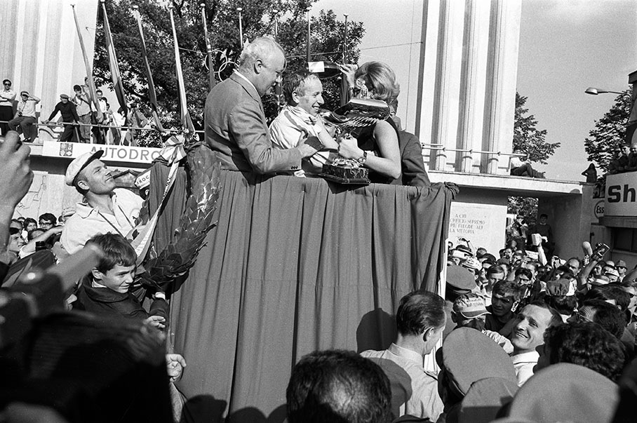 Race winner John Surtees takes his trophy on the podium after the Italian GP, Monza 1967