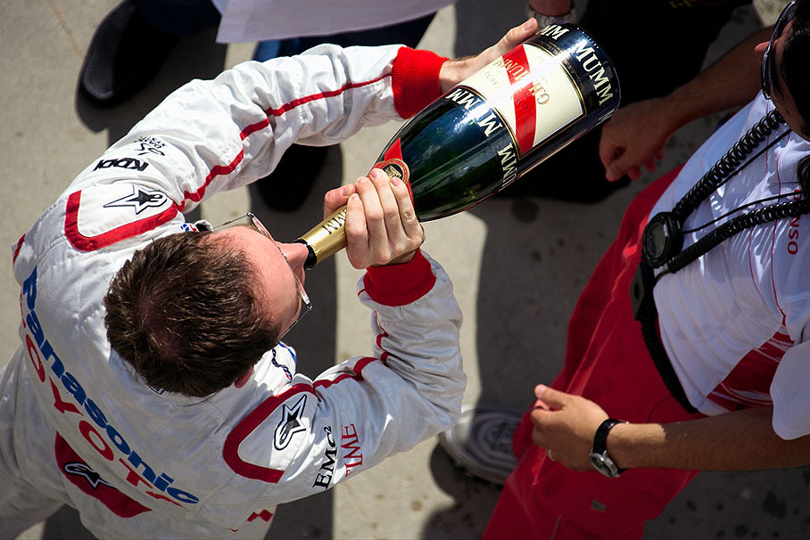 A Toyota mechanic quenches his thirst from cheering with Glock's champagne