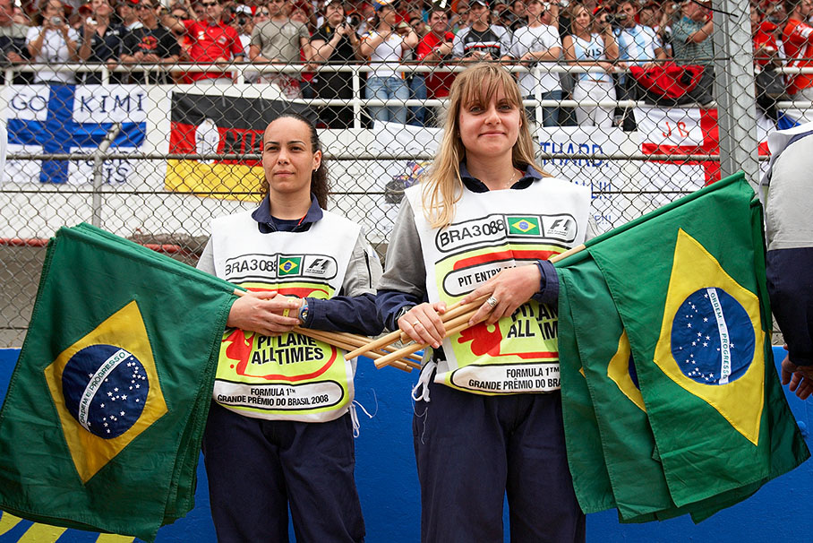 Brazilian officials hold their national flags which will be used for the drivers parade later