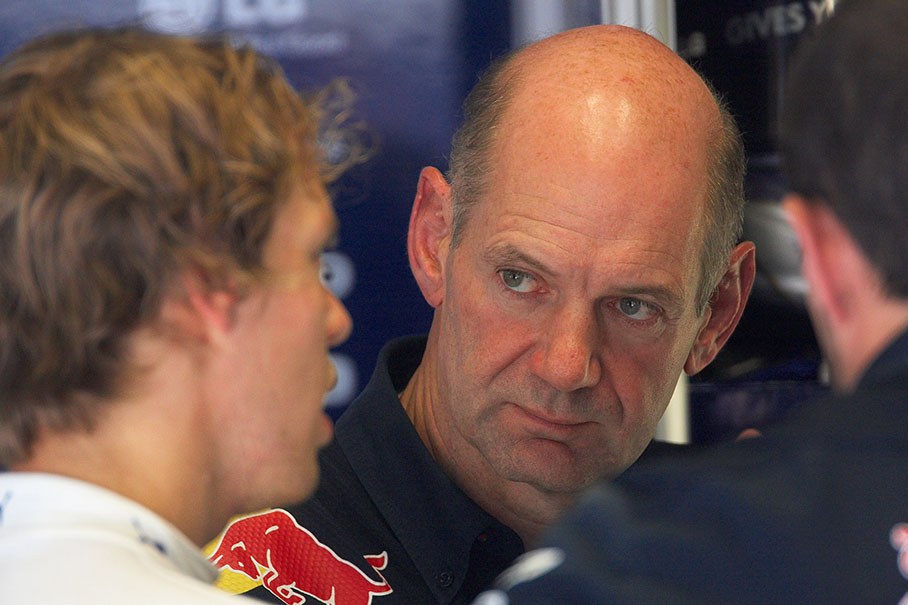 Adrian Newey, Red Bull Racing's chief designer, listens to Vettel's explanations
