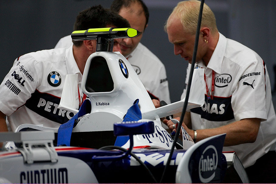 BMW Sauber mechanics work at the cars rear