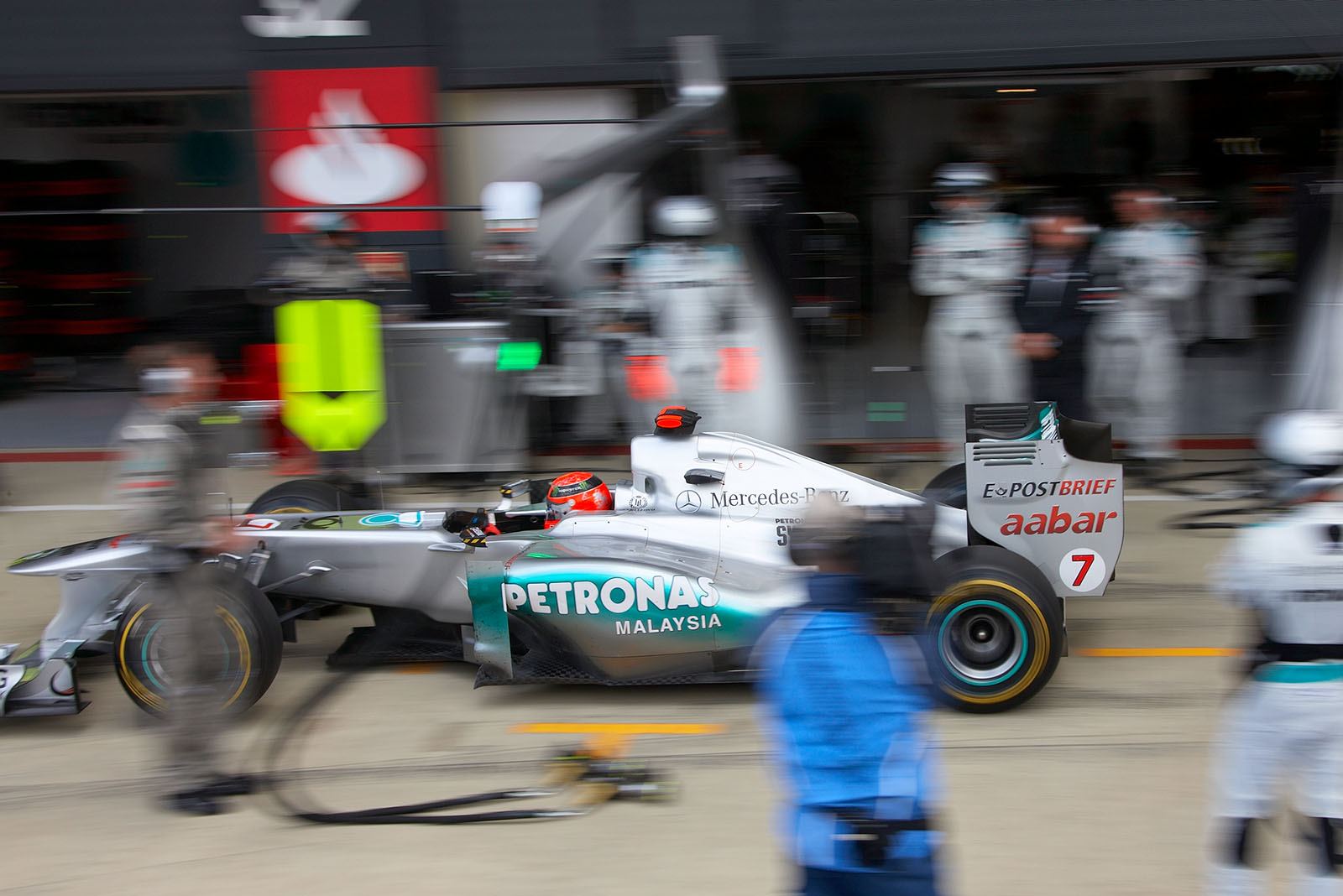 Michael Schumacher ejects from pits after a stop-n-go penalty