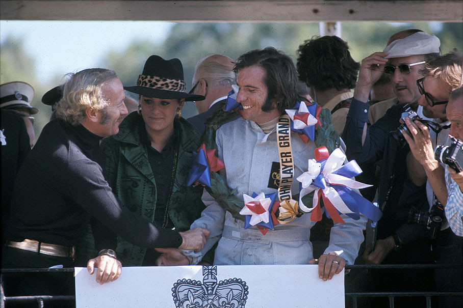 Emerson Fittipaldi receives congrats from Lotus team boss Colin Chapman on podium after the British GP Brands Hatch 1972