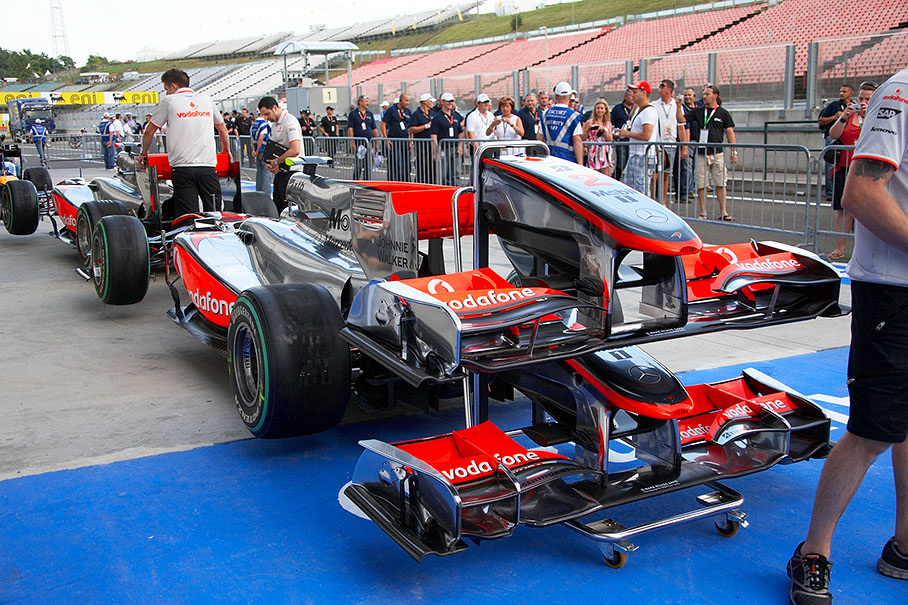 The McLaren cars wait in pit lane before scrutineering