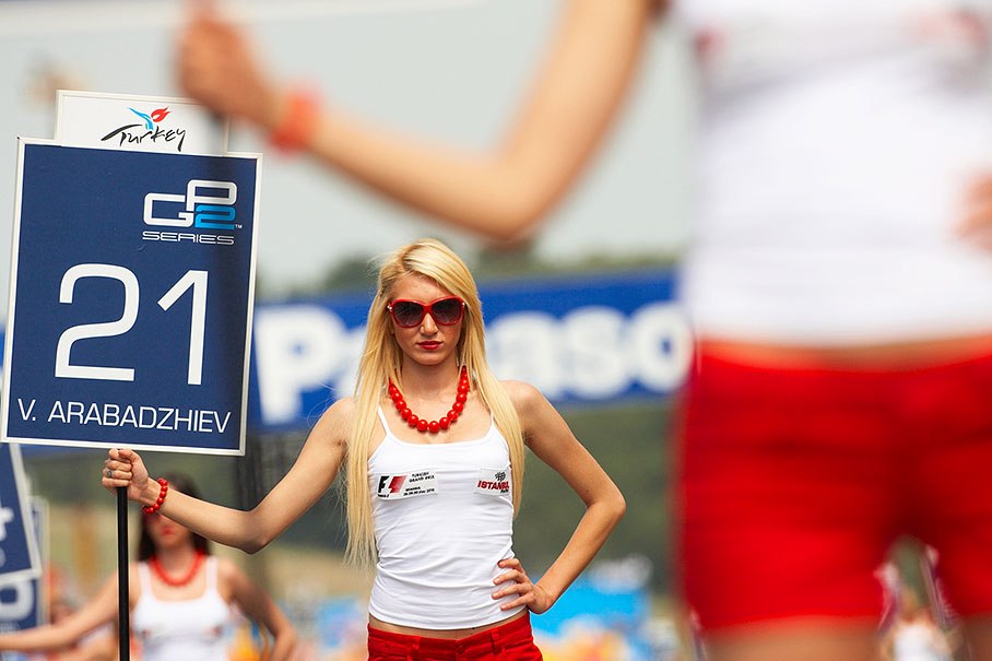 A Turkish grid girl holds a GP2 grid board