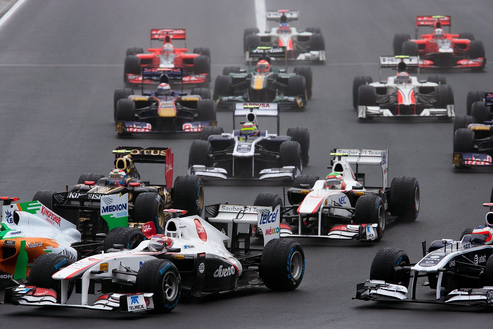 The pack squeezes into turn one