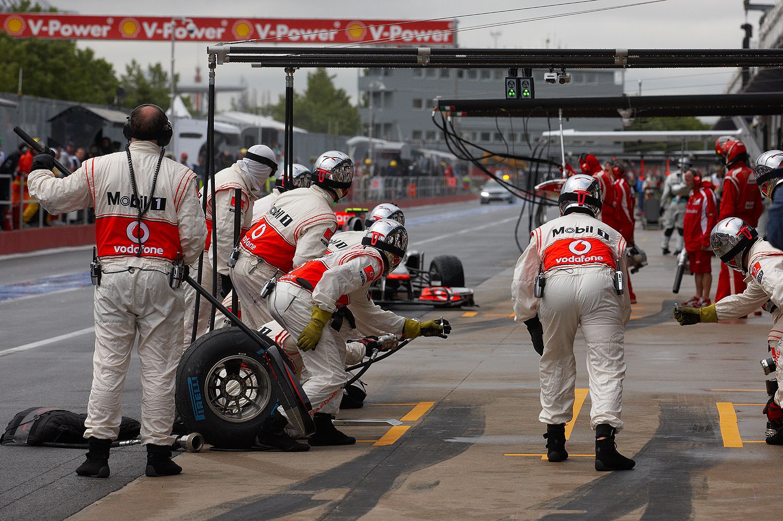 After his collision with Alonso, Jenson Button comes for an unexpected stop to McLaren pits with a flat tyre, the safety car deploys again