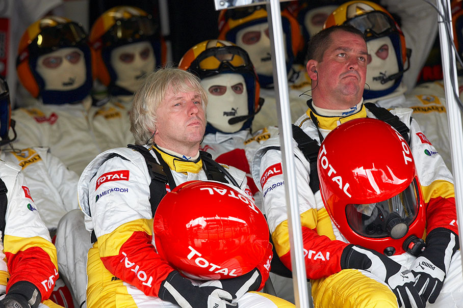 Renault mechanics wait in pits for their driver coming