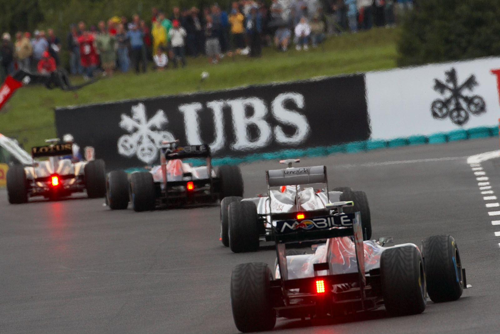 Race cars in line - Petrov, Buemi, Barrichello and Alguersuari head to the last corner