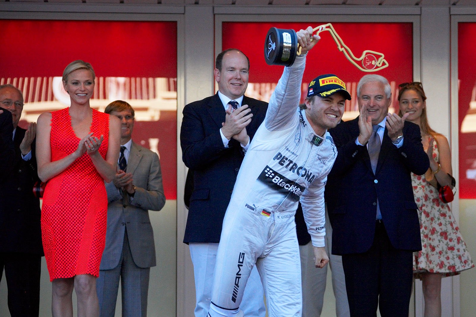Local hero and race winner Nico Rosberg of Mercedes celebrates his achievement and raises his trophy on the podium