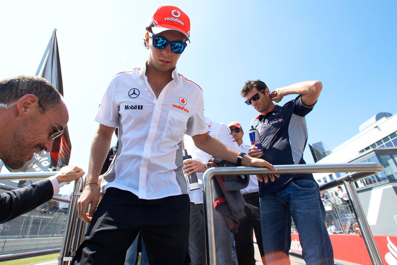 After the honoury lap, race drivers climb from the vehicle - Sergio Perez of McLaren is first