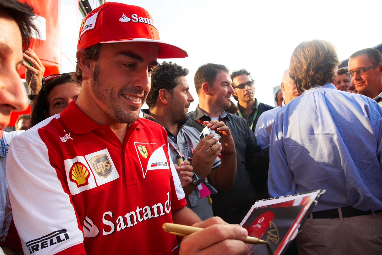 Fernando Alonso gives an autograph