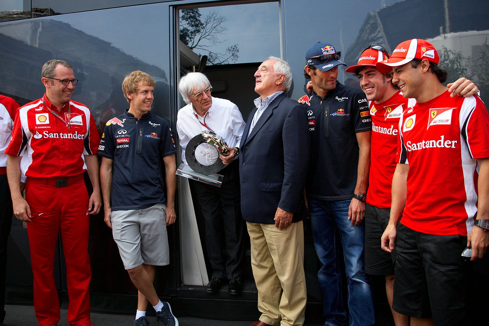 Bernie Ecclestone receives an honoury trophy from Brembo brakes chairman Alberto Bombassei, alongside stand Ferrari team boss Stefano Domenicali, Red Bull's Sebastian Vettel and Mark Webber and Ferrari drivers Alonso and Massa