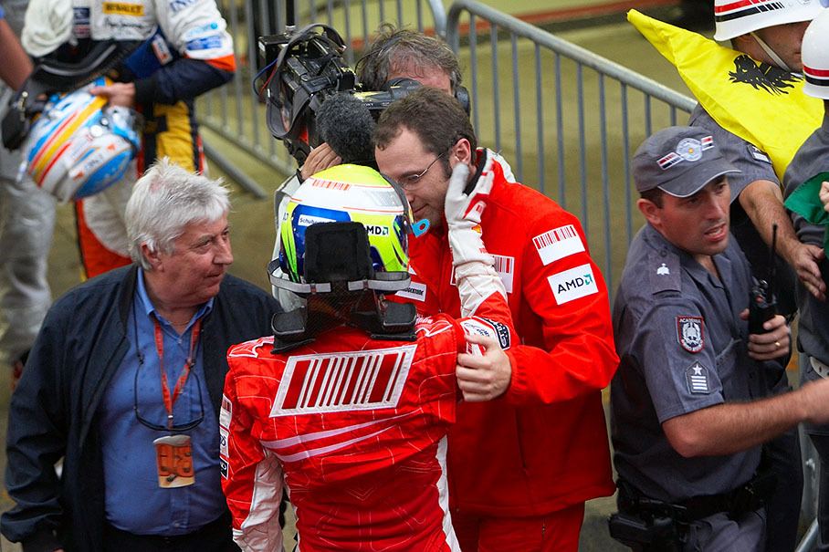Ferrari's Stefano Domenicaly and FIA race observer Herbie Blash console a very sad Massa after a highly exciting final race