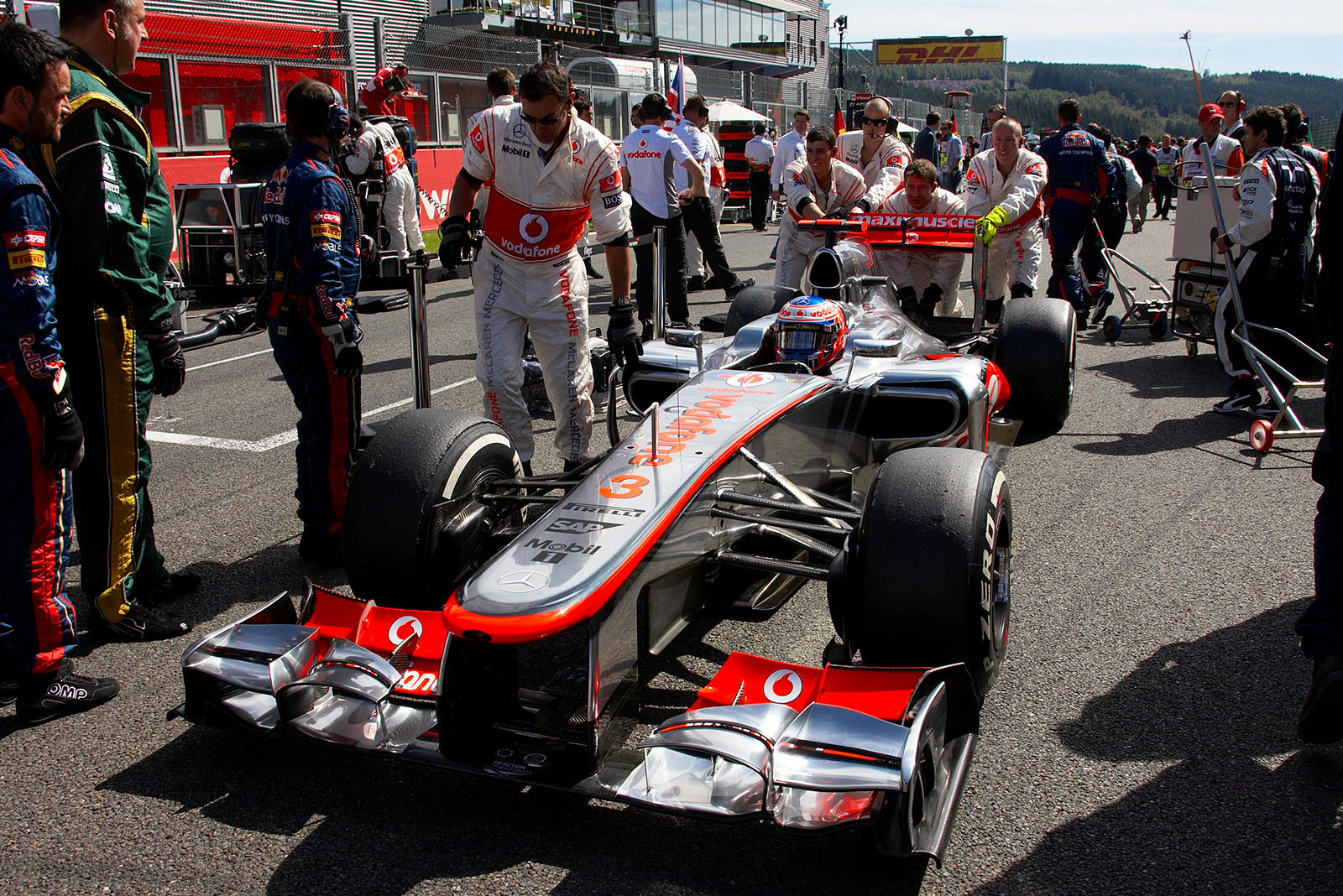 Jenson Button, McLaren Mercedes, is pushed to pole position