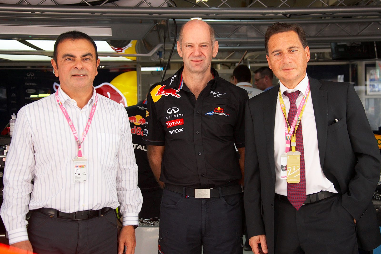 Carlos Ghosn, CEO of Renault-Nissan, Red Bull Racing technical director Adrian Newey and Eric Besson, French Minister of Industry, pose for a group photo in front of Red Bull pits