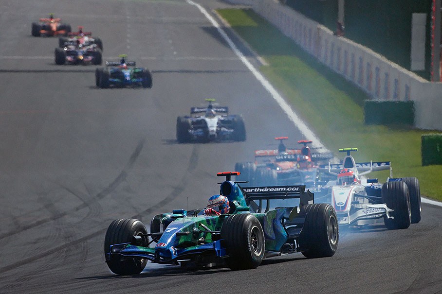 In front of the queue of chasers Jenson Button locks into La Source