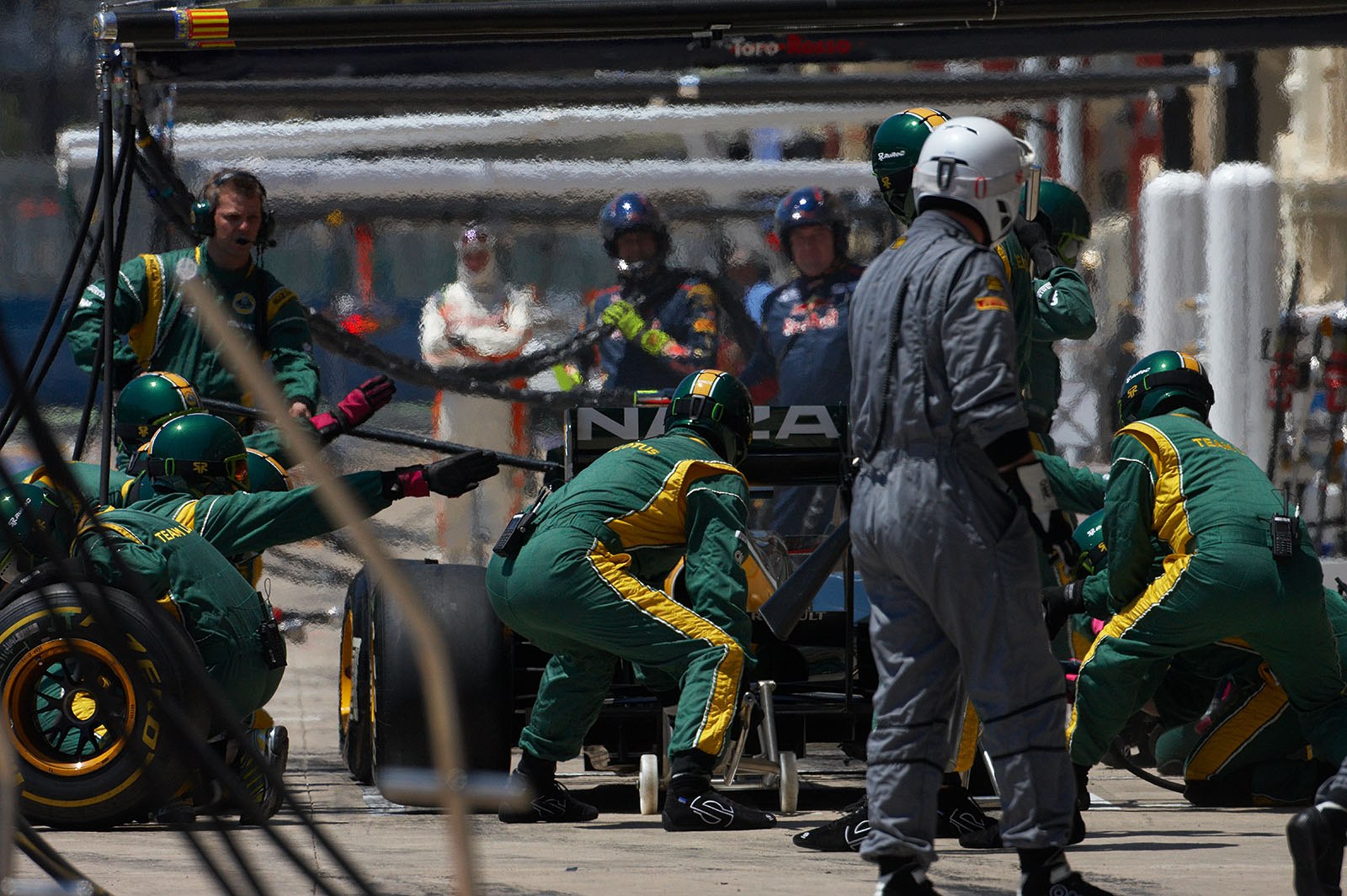 Jarno Trulli is serviced at Team Lotus pits