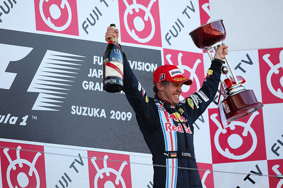 A gladiatorial Sebastian Vettel greets the world from Suzuka podium