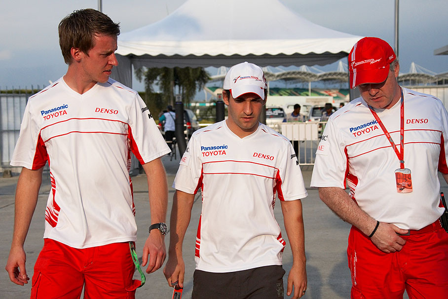 New German Toyota driver Timo Glock enters the paddock with physio Axel Thielmann and team manager Richard Cregan