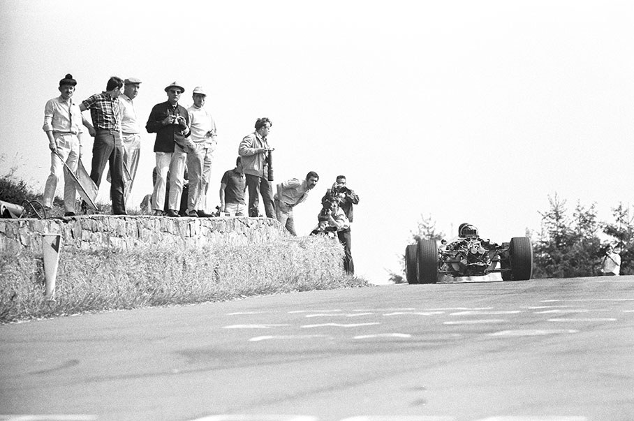 Eager photographers get close to the cars at the exit of Eau Rouge, Belgium GP 1967
