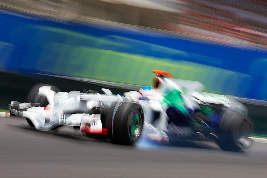 Honda's Jenson Button brakes into first turn