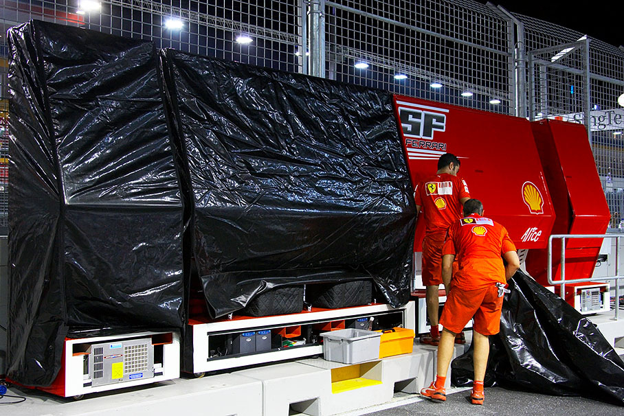 Ferrari mechanics wrap their equipment for its long journey to Japan