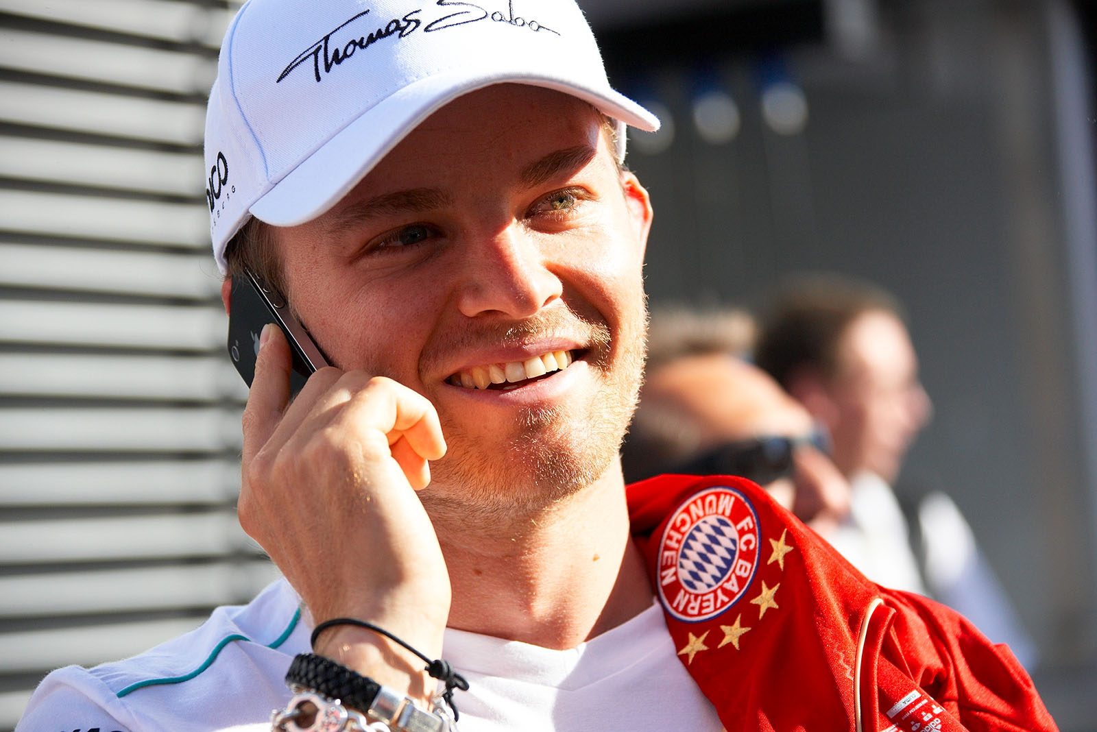 A confident looking FC Bayern fan Nico Rosberg phones home