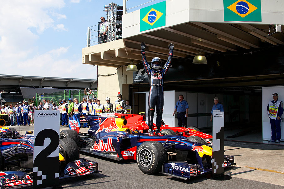 Race winner Sebastian Vettel jumps on the Red Bull Renault car and celebrates his victory and his win of the F1 Constructor's World Championship for the Red Bull Racing Team