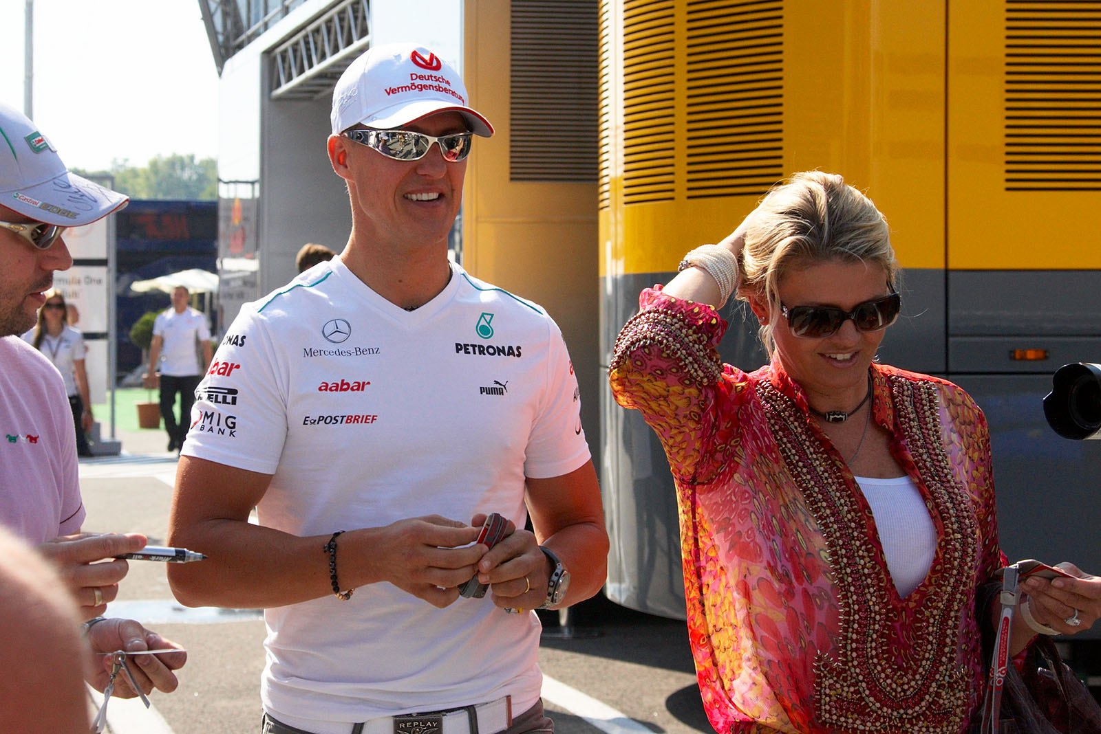 Michael Schumacher and his wife Corinna walk in the paddock