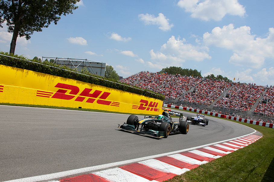 Heikki Kovalainen, Lotus Racing, in front of Barrichello