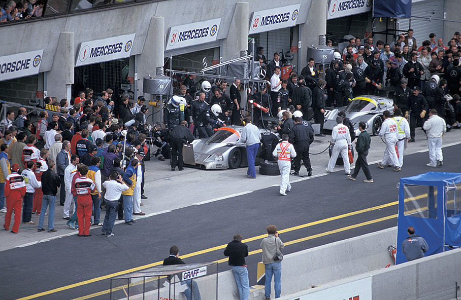 Michael Schumacher watches the pitstops of his luckless Team Sauber Mercedes team mates Jean-Louis Schlesser (F), Jochen Mass (D) and Alain Ferté (F) with car no. 1, the Mercedes-Benz C11 03, simultaneously stopping his drivers team's car no. 31 with Karl Wendlinger (A) and Fritz Kreutzpointner (D) on Mercedes-Benz C11 05