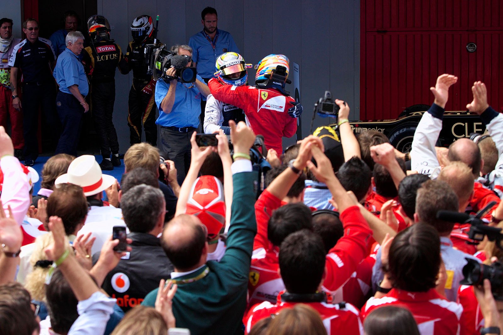 A victorious Pastor Maldonado of Williams is caressed by second placed Alonso in parc ferme after winning the Spanish Grand Prix 2012