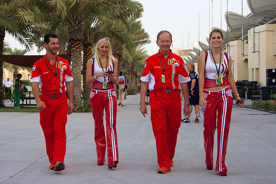 Ferrari hospitallity delegates and VIP hosts Filipo Marrai and Nigel Wollheim with two cigarette-branded hostesses