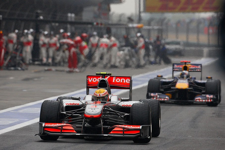 McLaren's Lewis Hamilton in front of Vettel in the pitlane