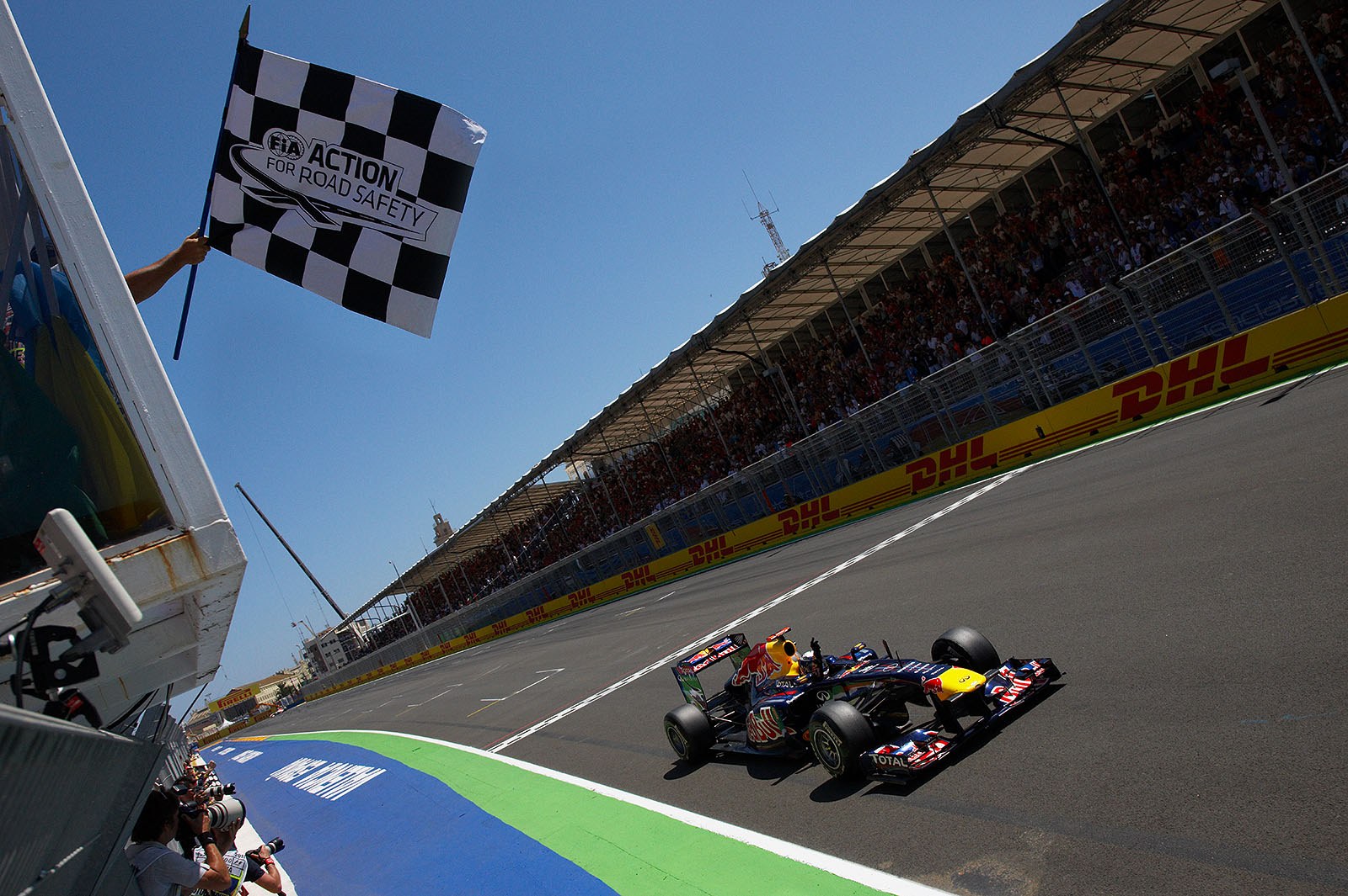 Sebastian Vettel, Red Bull Racing, takes the chequered flag and his sixth win of the season