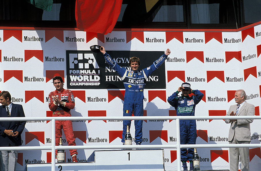 Podium ceremony of the Hungarian Grand Prix 1990: winner Thierry Boutsen, second placed Ayrton Senna and third placed Nelson Piquet
