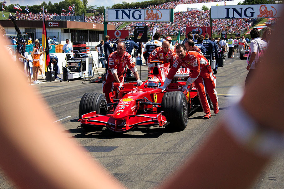 Raikkonen is being pushed by Ferrari mechanics to his grid position