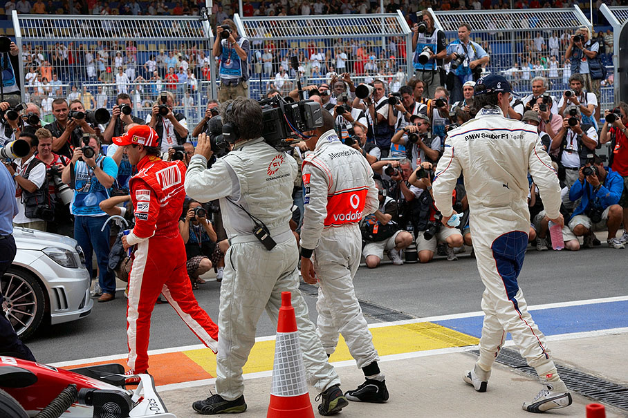 The three fastest qualifiers leave parc ferme after the group photo