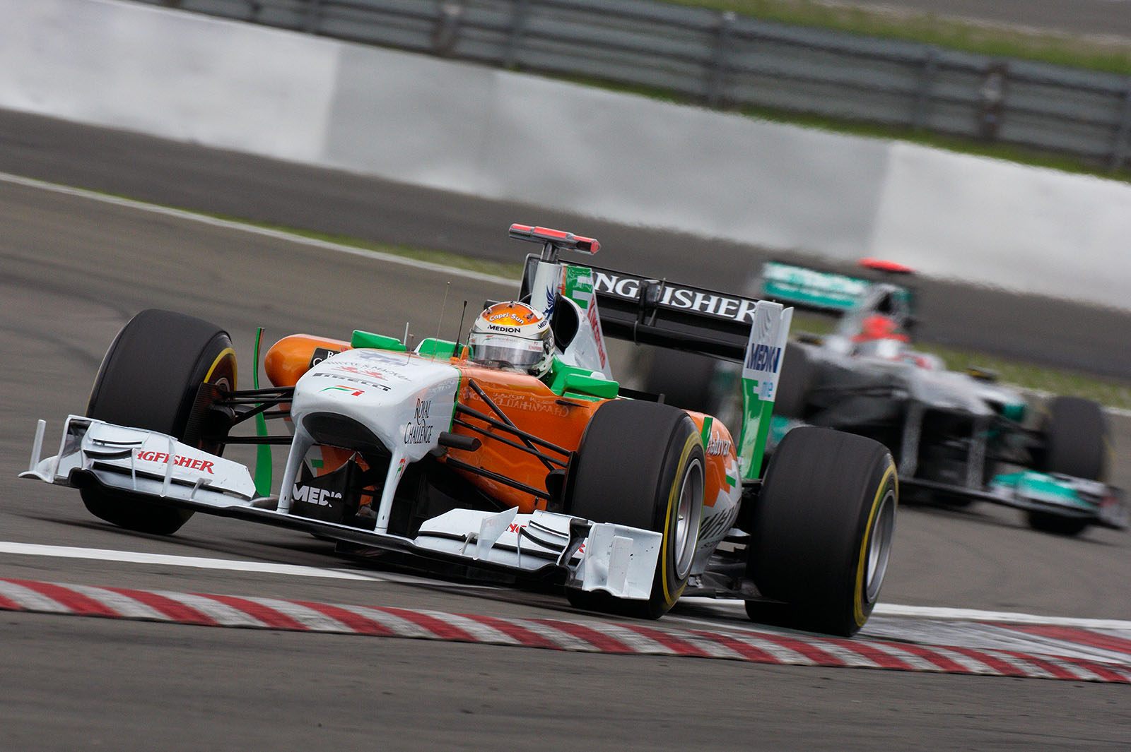 Adrian Sutil, Force India F1 Team, leads Michael Schumacher