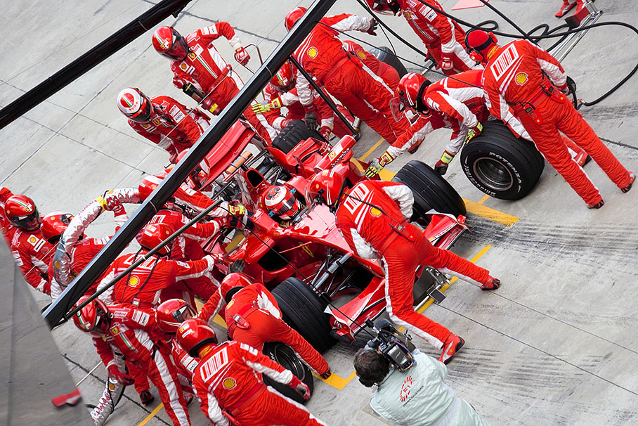 Raikkonen in Ferrari pits during 18th lap, taking the lead from teammate Massa