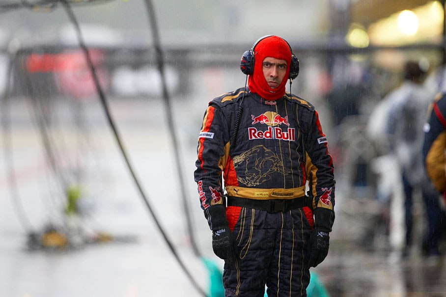 A Toro Rosso mechanic looks for better weather