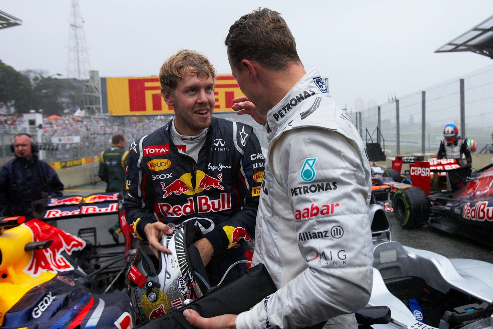 New triple World Champion Sebastian Vettel, Red Bull Racing, chats with leaving Champion Schumacher in parc ferme