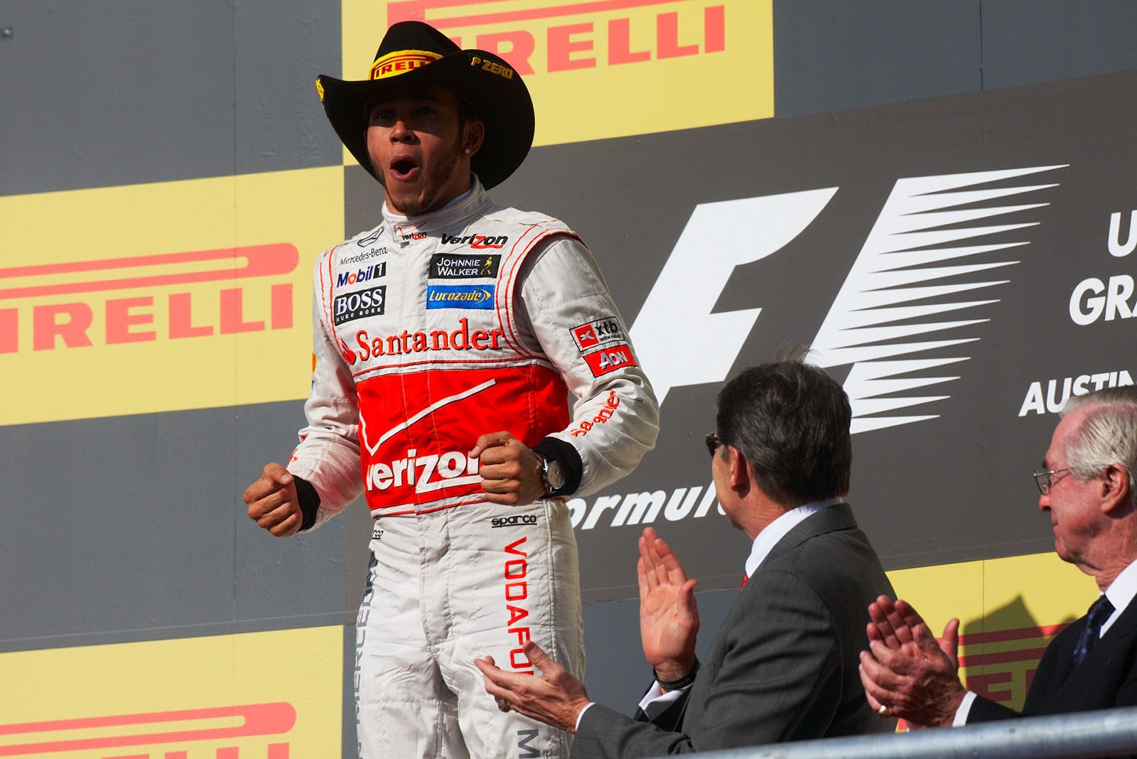 Race winner Lewis Hamilton of McLaren celebrates at the rostrum