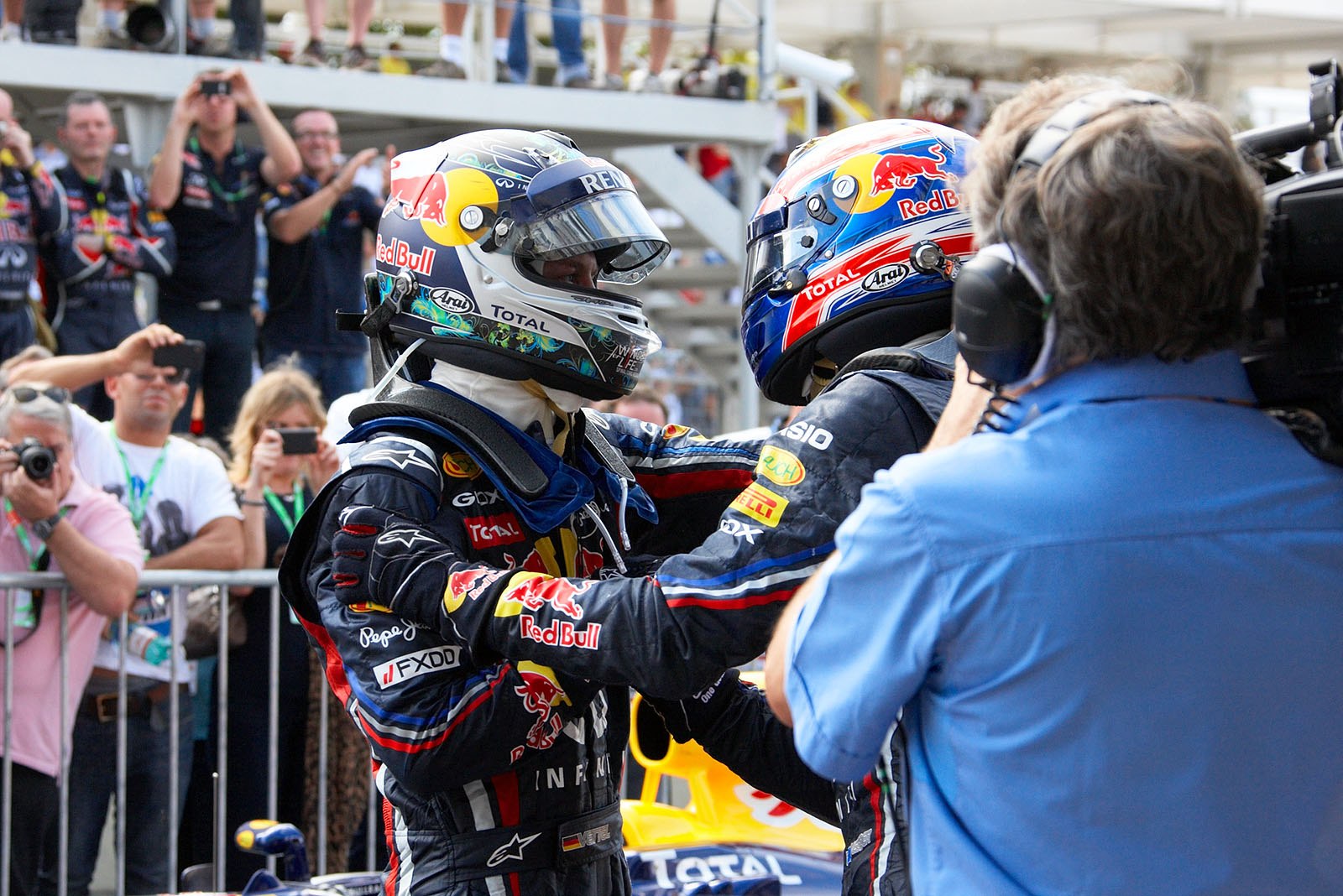 Red Bull's race winner Webber and second placed team mate Vettel caress each other in parc ferme after the Brazilian Grand Prix, finalising the superior season for Red Bull