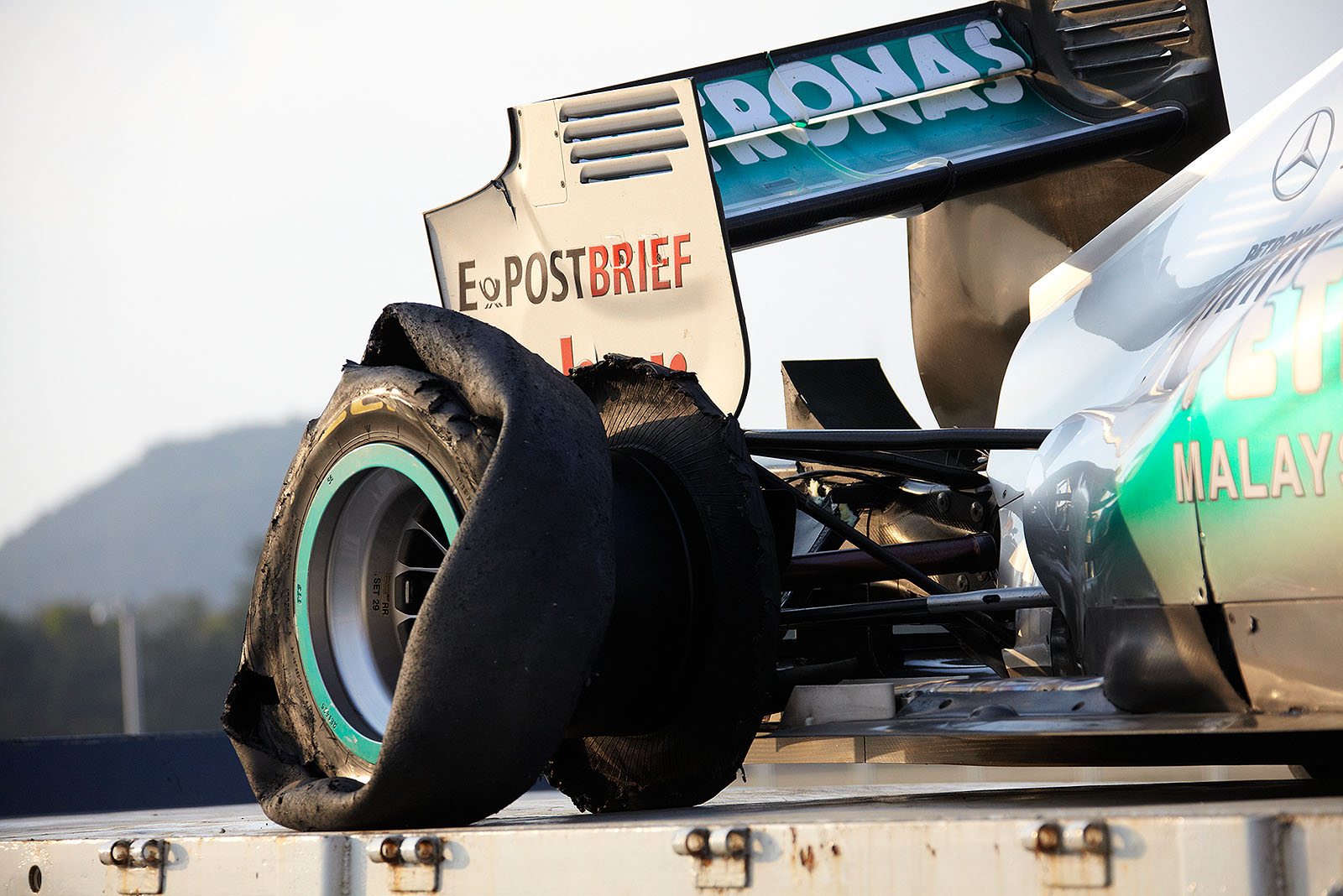 Schumacher's Mercedes car is being returned to pits after a collision during the Korean GP