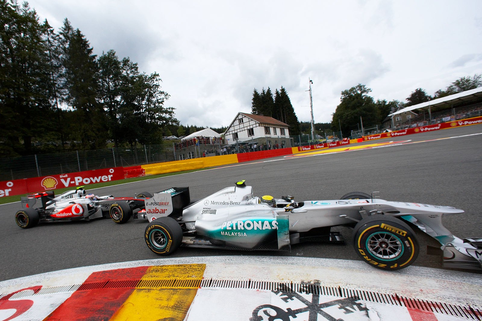 In the last third of the race Nico Rosberg on Mercedes is constantly under attack by Jenson Button's McLaren Mercedes